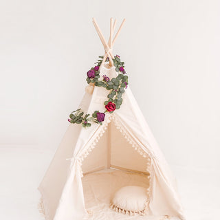 Lush eucalyptus and peony garland used as nursery decoration, adding a natural touch.