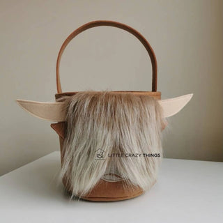 Brown felt bag with faux fur hair and horns, branded 'Little Crazy Things'.